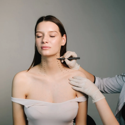 Woman in a revealing dress showing her neckline and how someone may be drawing on it for a necklift.
